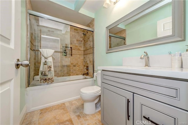 full bathroom featuring toilet, vanity, and shower / bath combination with glass door