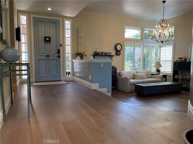 foyer featuring hardwood / wood-style floors and a notable chandelier