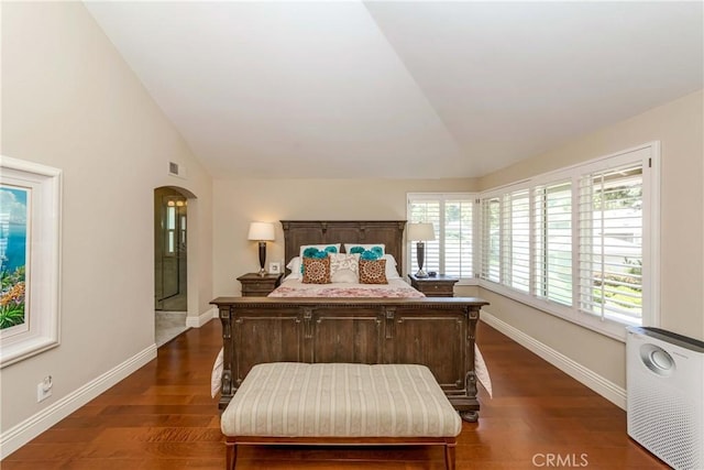 bedroom featuring dark hardwood / wood-style flooring and lofted ceiling