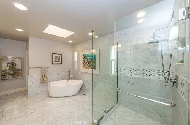 bathroom featuring a skylight and shower with separate bathtub