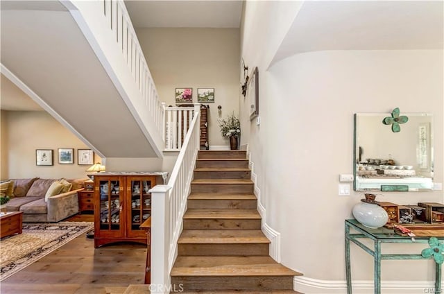 staircase with hardwood / wood-style floors