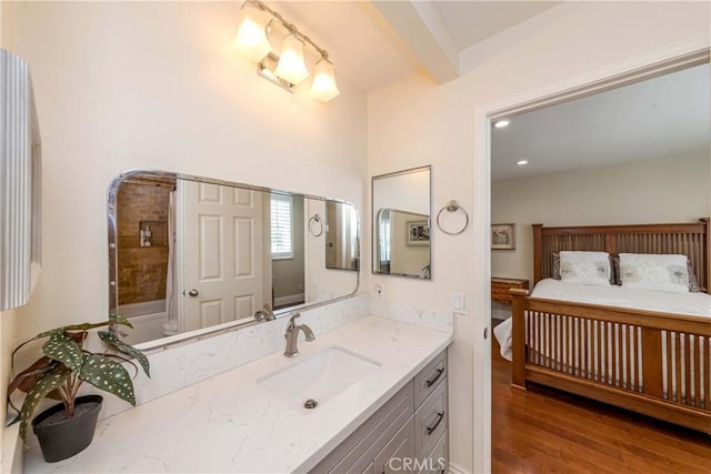 bathroom featuring vanity, tub / shower combination, hardwood / wood-style floors, and beam ceiling