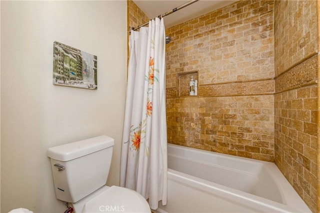 bathroom featuring shower / bath combo and toilet