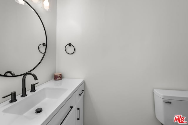 bathroom featuring toilet and vanity