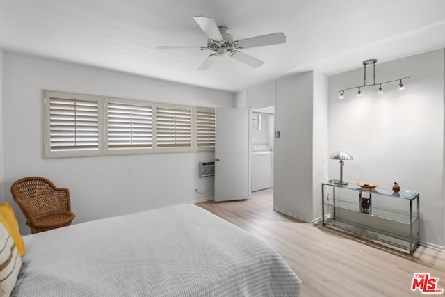 bedroom with ceiling fan, light hardwood / wood-style flooring, washer / clothes dryer, and ensuite bath