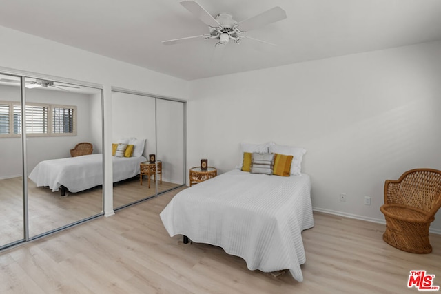 bedroom featuring light wood-type flooring, two closets, and ceiling fan