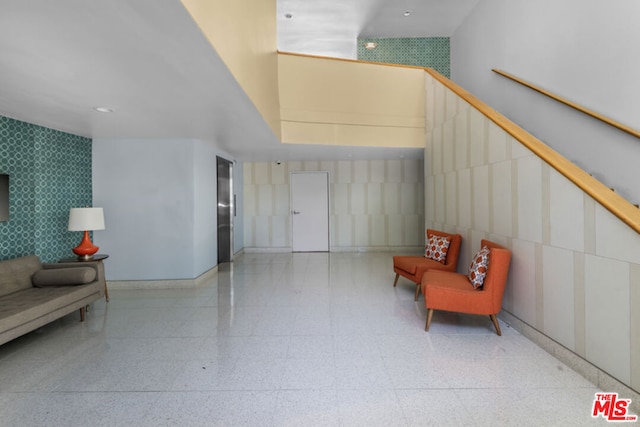 living area featuring a towering ceiling