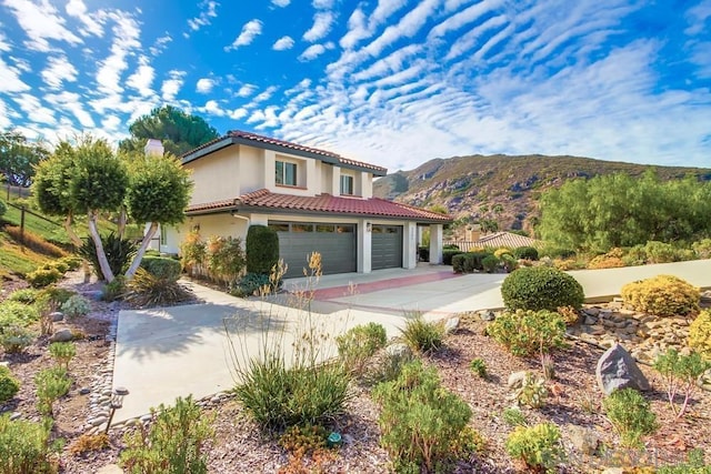 view of front of house with a garage and a mountain view