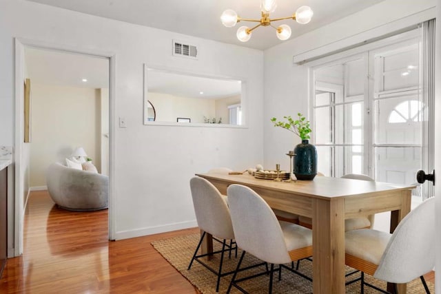 dining room with a notable chandelier and light hardwood / wood-style floors