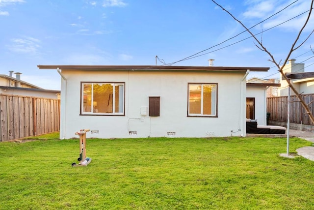 rear view of property with a yard