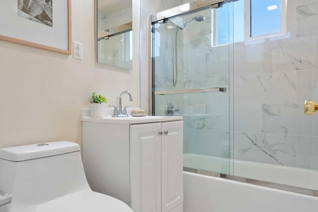 full bathroom with vanity, bath / shower combo with glass door, and toilet