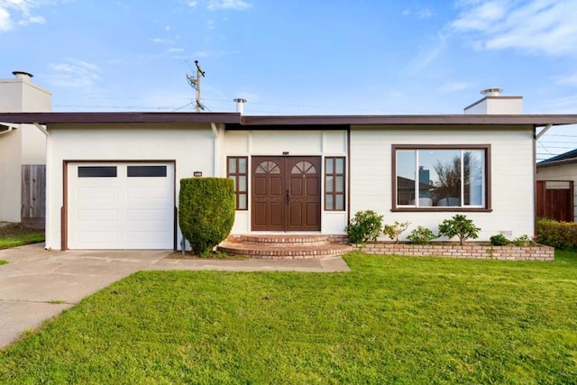 ranch-style home with a garage and a front lawn