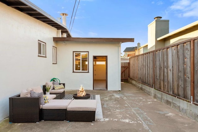 view of patio / terrace with an outdoor living space with a fire pit