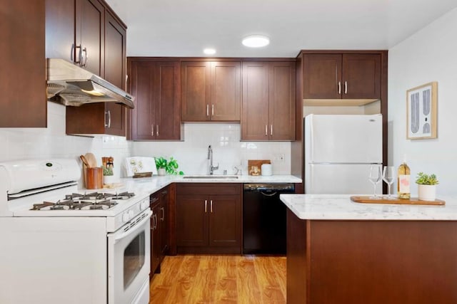 kitchen featuring tasteful backsplash, white appliances, sink, and light hardwood / wood-style flooring