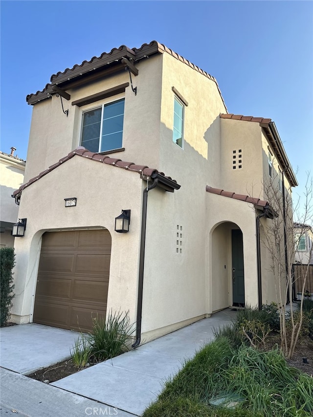 mediterranean / spanish-style home with a garage