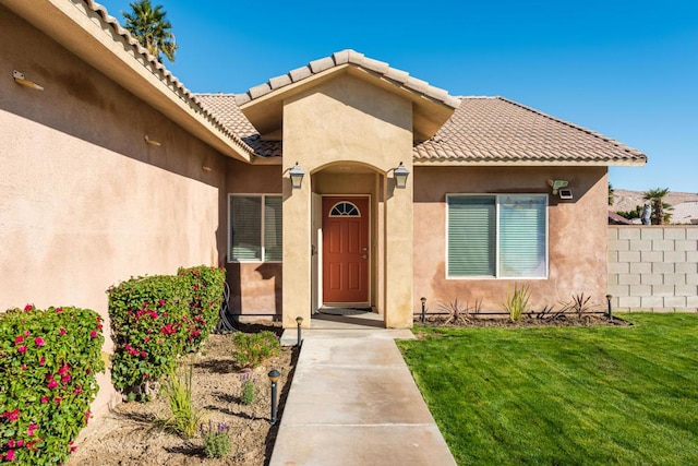 entrance to property with a yard