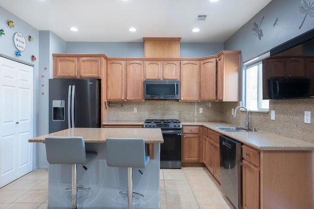 kitchen with stainless steel appliances, decorative backsplash, sink, light tile patterned flooring, and light stone counters