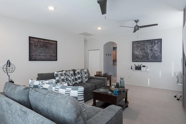 carpeted living room featuring ceiling fan