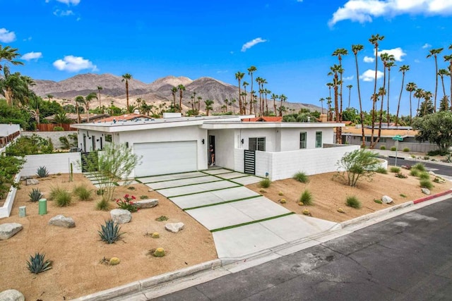 view of front of property with a garage and a mountain view