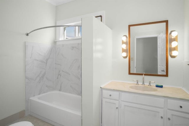 full bathroom featuring tiled shower / bath combo, toilet, and vanity