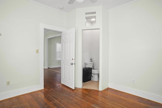 unfurnished room with crown molding, dark wood-type flooring, and ceiling fan