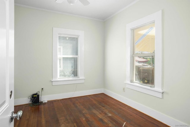 unfurnished room with crown molding, dark wood-type flooring, and a wealth of natural light