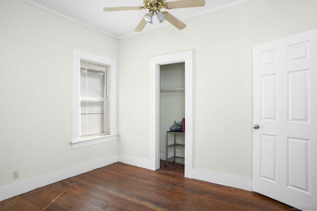 unfurnished bedroom featuring ceiling fan, ornamental molding, and dark wood-type flooring