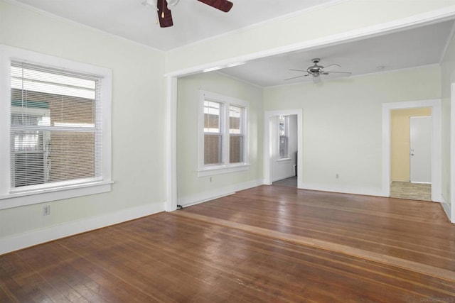 spare room with dark wood-type flooring, ceiling fan, and ornamental molding