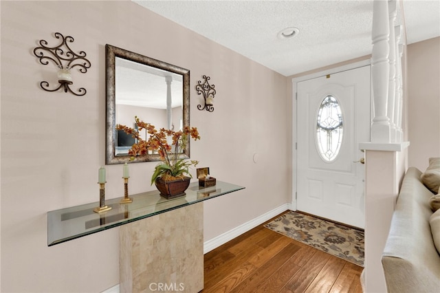 foyer featuring a textured ceiling and hardwood / wood-style floors