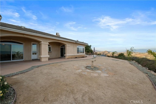 rear view of house with a patio