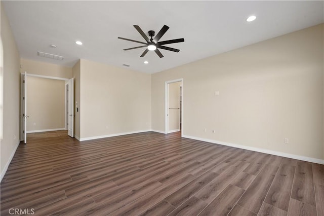 spare room with ceiling fan and dark hardwood / wood-style floors