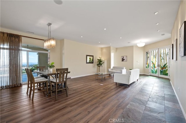 dining area with plenty of natural light and dark wood-type flooring