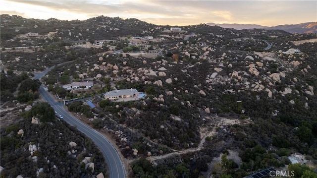 aerial view at dusk featuring a mountain view