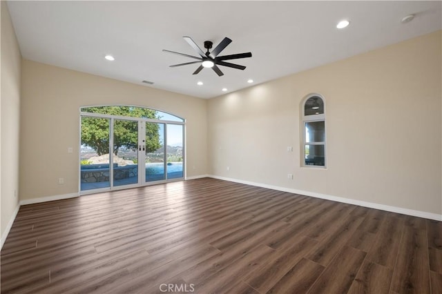 spare room with dark wood-type flooring and ceiling fan