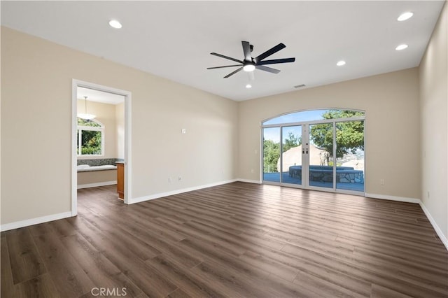 spare room featuring dark hardwood / wood-style floors and ceiling fan