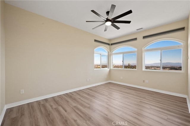 spare room with light hardwood / wood-style floors and ceiling fan