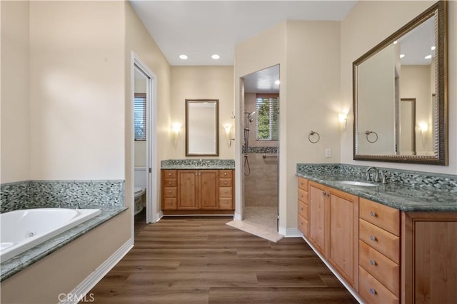 full bathroom with vanity, toilet, separate shower and tub, and wood-type flooring