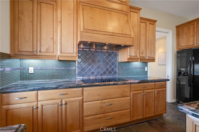 kitchen with premium range hood, dark stone countertops, black appliances, and tasteful backsplash