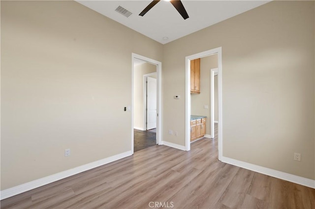 unfurnished room featuring ceiling fan and light hardwood / wood-style flooring