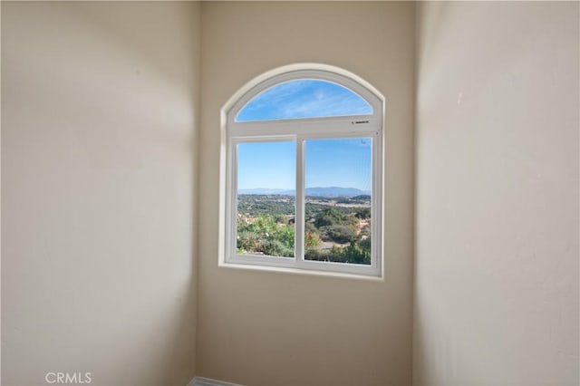 unfurnished room featuring a mountain view