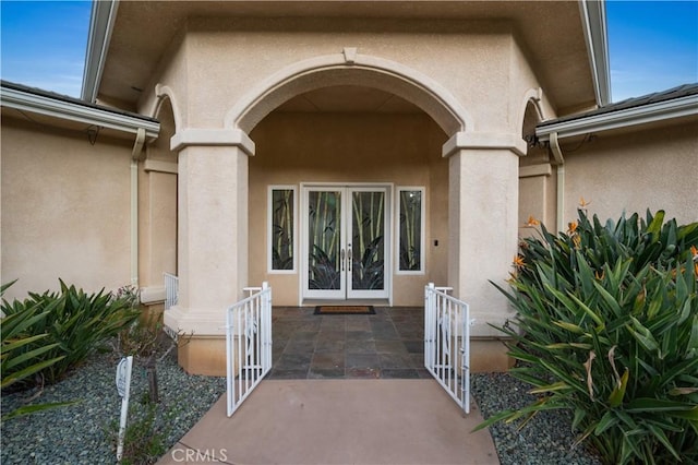 entrance to property featuring french doors and a patio