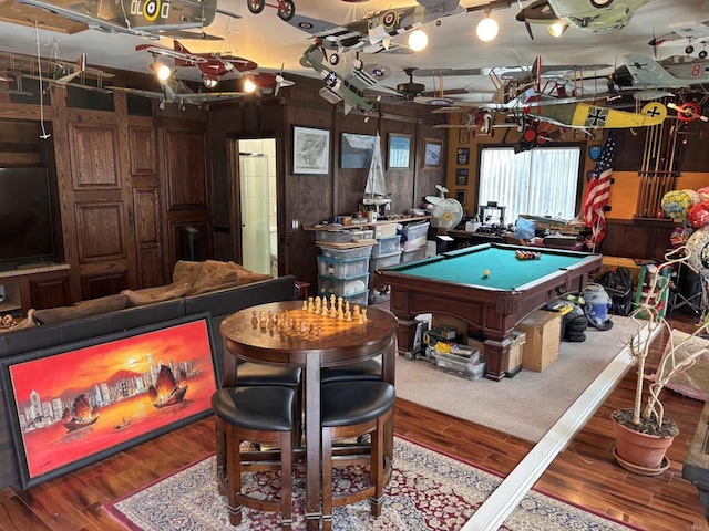 rec room with pool table, wooden walls, and wood finished floors