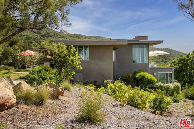 view of side of home with a mountain view