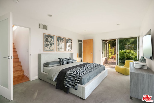 bedroom with access to outside and carpet floors