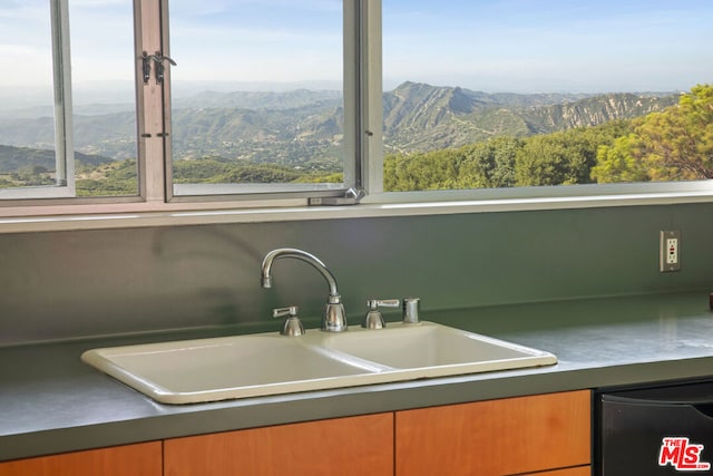 kitchen featuring sink, a mountain view, and dishwasher