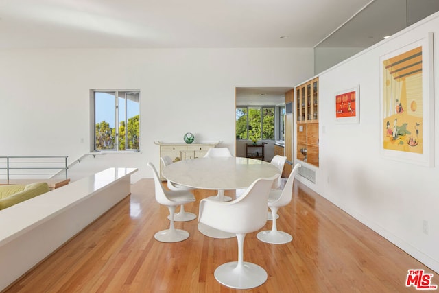 dining space featuring a wealth of natural light and light hardwood / wood-style floors