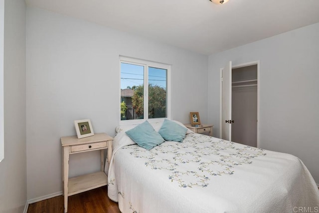 bedroom with a closet and dark hardwood / wood-style flooring