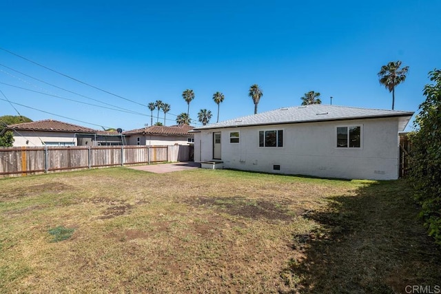 back of property featuring a lawn