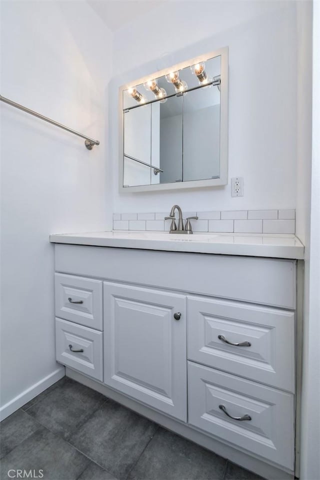 bathroom featuring tile patterned flooring, vanity, and baseboards