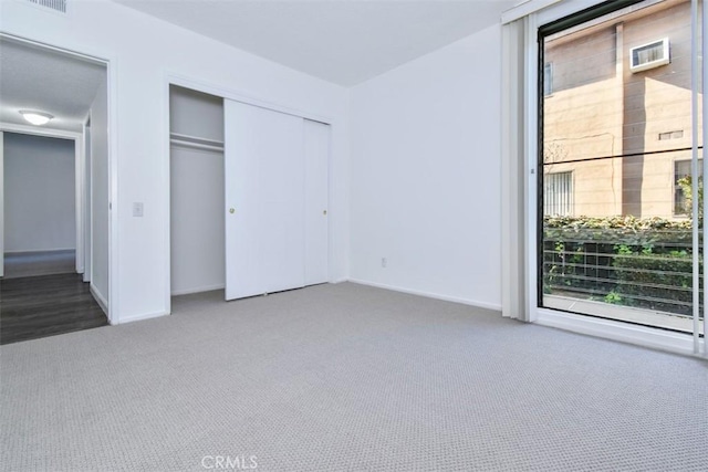 unfurnished bedroom with carpet floors and a closet